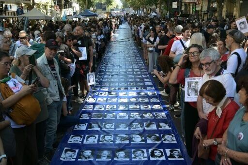 Marchers with pictures of loved ones who disappeared without trace during the dictatorship
