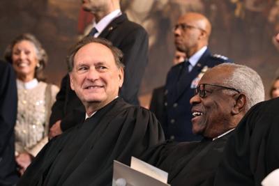 Supreme Court Justices Samuel Alito and Clarence Thomas share a laugh at the U.S. Capitol on Jan. 20, 2025.