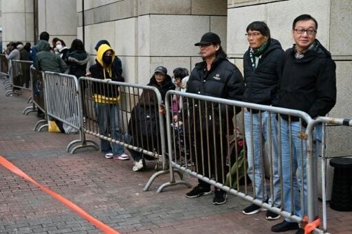 People queue outside a Hong Kong court for the sentencing arguments of convicted pro-democracy media tycoon Jimmy Lai