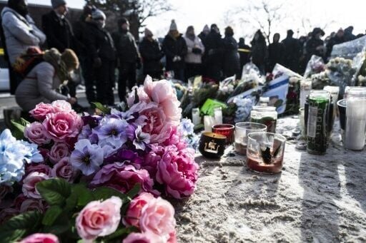 The makeshift memorial in the snow was decorated with bouquets of flowers and candles