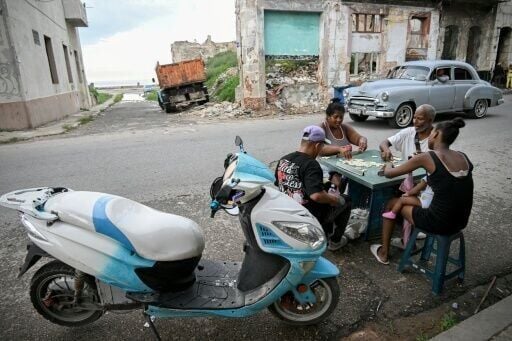 Cubans play dominoes on a street in Havana