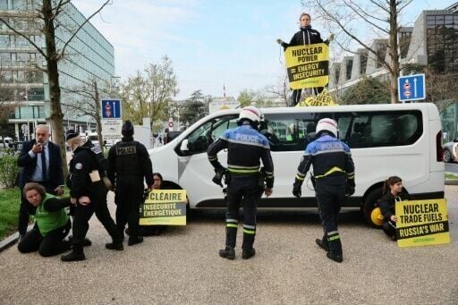 Greenpeace activists stage a protest as a nuclear energy summit opened in Boulogne-Billancourt outside Paris