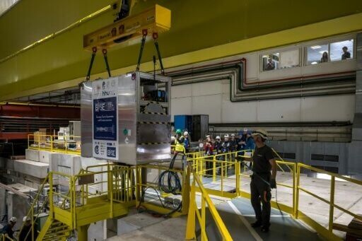 A specially designed portable cryogenic Penning trap device filled with a cloud of 92 antiprotons is transferred onto the truck before the test drive begins