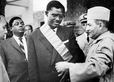Lumumba (centre), pictured here in 1960, was an outspoken critic of Belgium's colonial rule
