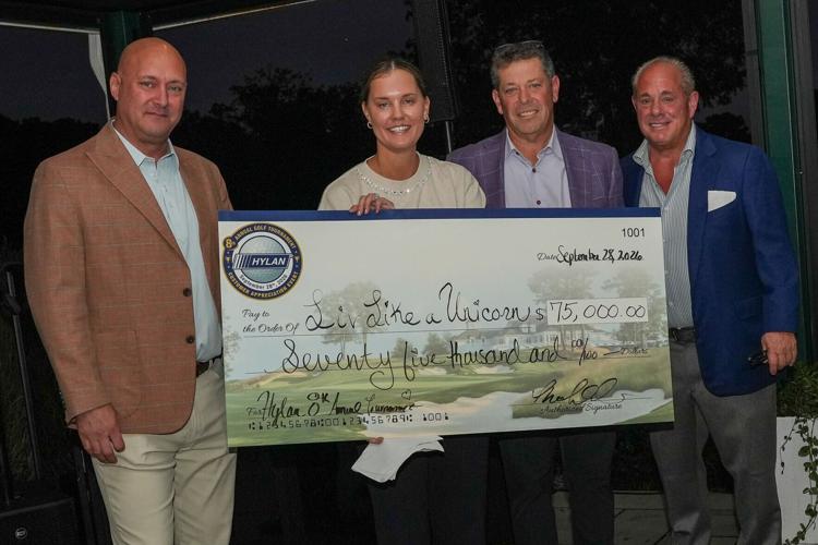 HYLAN presents a $75,000 check to Emma Lipnicky, Executive Director of Liv Like a Unicorn, during the evening reception of HYLAN’s 8th Annual Golf Tournament.