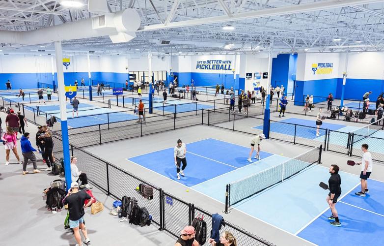 Inside a Pickleball Kingdom location featuring multiple indoor courts.