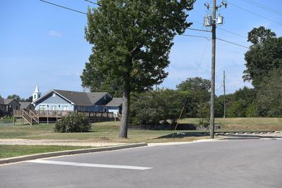 Cliff Williams / TPI The lot at 208 Marshall Street is pictured from the green space near the Farmers Market. The blue home belongs to Janice Vance. She and other neighbors contend the lot should not be rezoned to allow a restaurant or other business.