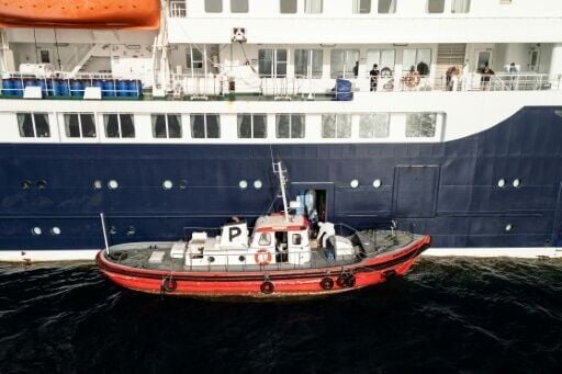 Health personnel boarding the cruise ship MV Hondius in the waters off Praia