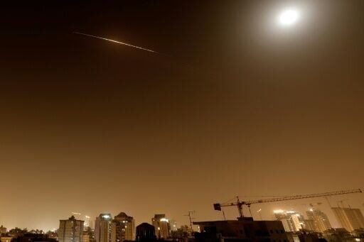 Rocket trails are seen in the sky above the Netanya, Israel