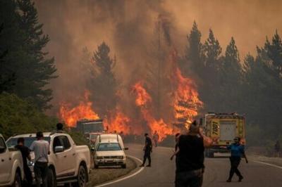 Firefighters battle to extinguish a bushfire in Chubut province of Argentina's Patagonian region