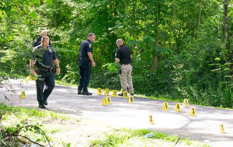 Alexander City police officers work the scene of a shooting on N street