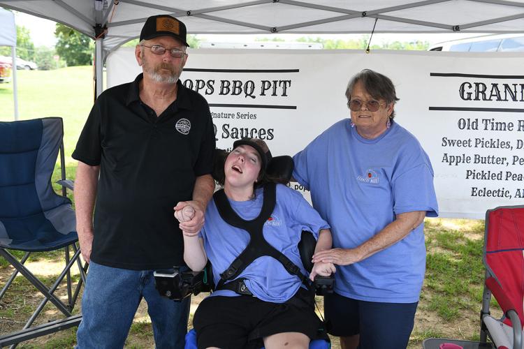 Cliff Williams / TPI Kevin Thompson, left, poses with Jean Thompson and Barbra Thompson. The family has BBQ spices, pickles and relishes.