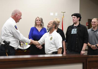 Cliff Williams / TPI New Millbrook fire chief Doyle Campbell, left, is congratulated by retiring fire chief Larry Brown after Campbell was sworn in last week.