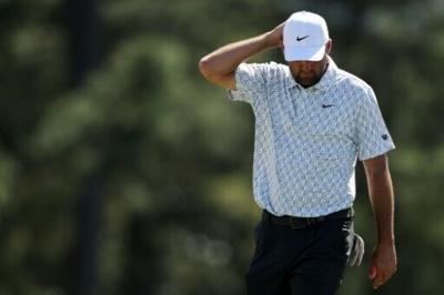 Top-ranked Scottie Scheffler ponders on the 18th green after firing a two-over par 74 in the second round of the Masters