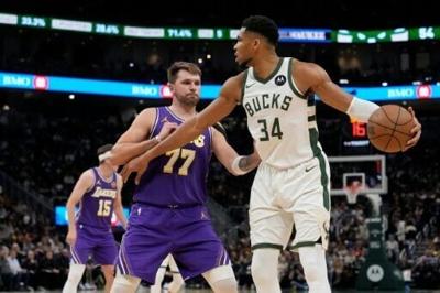 Milwaukee's Giannis Antetokounmpo, right, and Los Angeles Lakers star Luka Doncic, center, were the leaders in the latest fan voting returns announced for the 2026 NBA All-Star tournament by the league