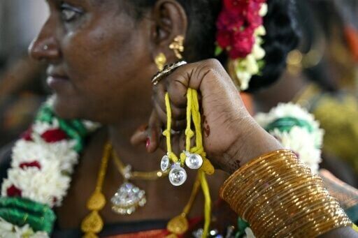 A member of the transgender community holds "thali", a sacred thread symbolising marriage to Hindu warrior god Aravan