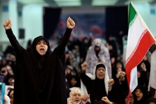 Iranian Shia women shout slogans during Eid al-Fitr prayers, marking the end of the Muslim holy month of Ramadan, despite the threat of intensified US and Israeli air strikes