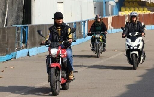 Instructor Maryam Ghelich (L) gives women students a lesson in riding motorbikes at a training centre in northern Tehran