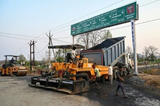 Road workers tar one of the new highways India has pushed into the former Maoist bastion