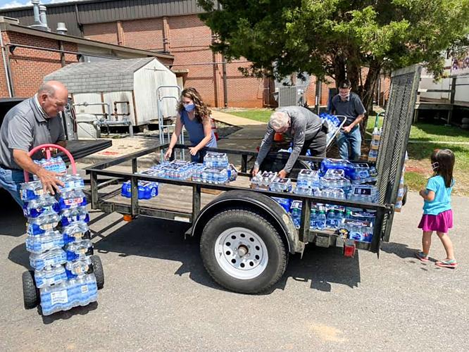 Alex City Church of Christ donates water to schools