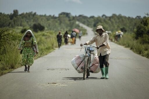 Displaced people pushed their belongings as they returned home after the takeover of Uvira