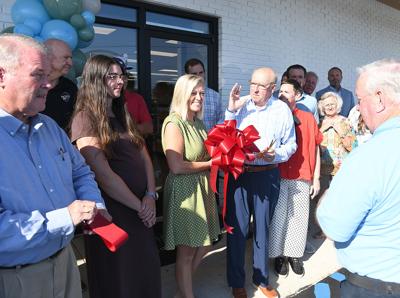 Cliff Williams / TPI Adams Drugs pharmacist Merranda Smith, center, smiles as owner Mike Vincent talks about being open in Tallassee.