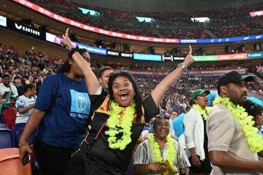 Fiji fans cheer their team at the Kai Tak sports stadium