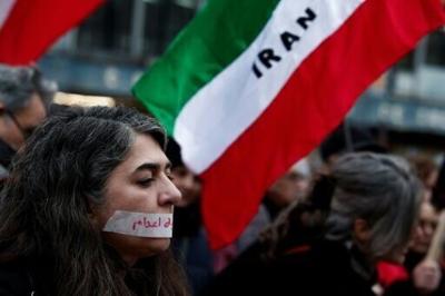 A demonstrator in Paris wears a sticker over her mouth with the words "no execution" prior to a silent march denouncing the Iranian government's deadly crackdown on anti-government protesters in the Islamic Republic