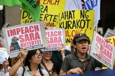 Protesters call for the impeachment of Philippine Vice President Sara Duterte outside the House of Representatives on Monday as hearings began