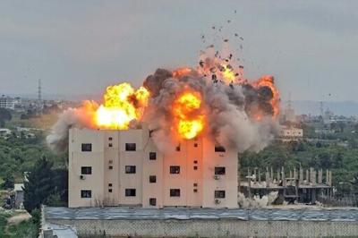 An Israeli airstike hits a building in Lebanon, in the southern village of Abbasiyyeh, on March 13