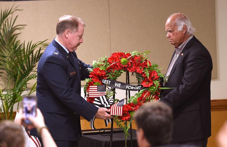 Cliff Williams / TPI Rev. Dr. Brannon Bowman, left, and Millbrook Mayor Al Kelley lay a wreath as part of the city’s Memorial Day Observance on Friday.