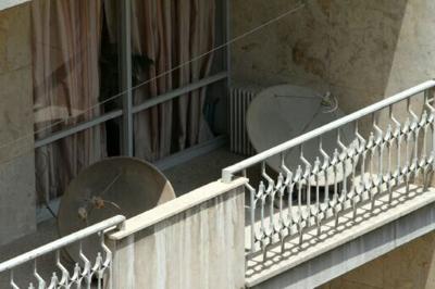 Satellite dishes on a balcony in Tehran. The authorities have often cracked down on their use
