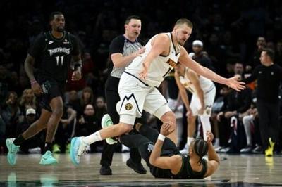 Jaylen Clark #22 of the Minnesota Timberwolves and Nikola Jokic #15 of the Denver Nuggets