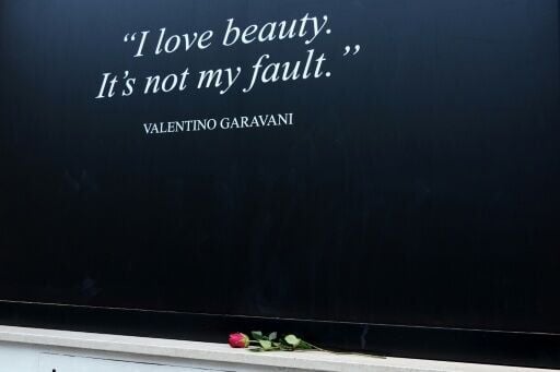 Mourners have laid tributes at the designer's shop in Rome