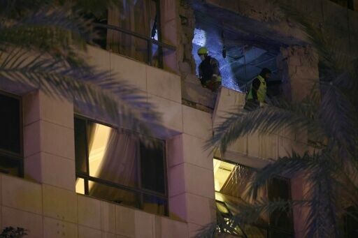Lebanese first responders inspect a Beirut hotel room targeted by the Israeli strike