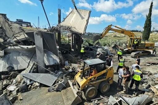 First responders search for survivors amongst the rubble at the site of an Israeli airstrike