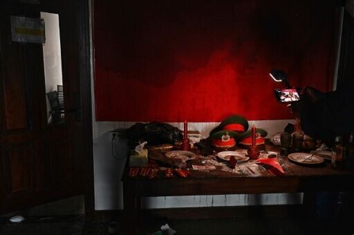 Replica Vietnamese police hats inside an abandoned scam centre in O'Smach town on the Thai-Cambodian border