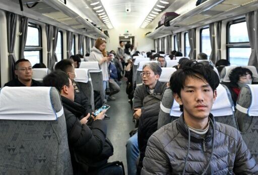 People board the K27 train bound for Pyongyang at Beijing Railway Station in Beijing on March 12, 2026