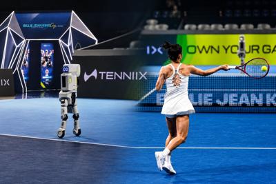 Chinese tennis player Wang Qiang returns a shot against the TENNIIX Ultra max ULTRA MAX embodied AI robot during its demonstration at the Billie Jean King Cup Finals.
