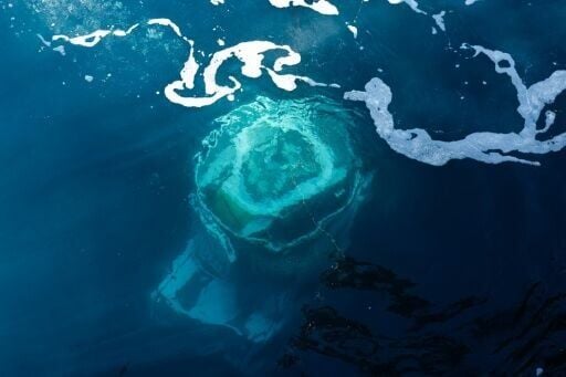 Archeologists use a remote-controlled robot with pincers and cameras to plunge to more than 2,000 metres deep