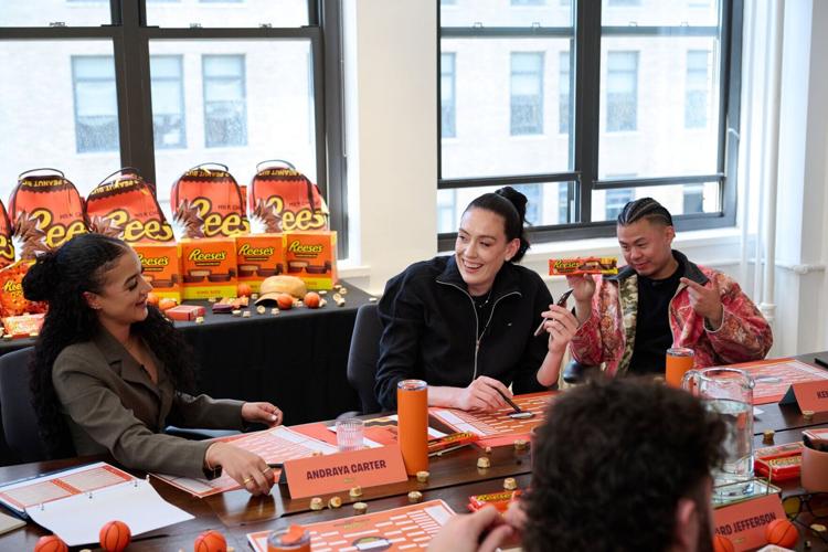 Andraya Carter, Breanna Stewart, and Kenny Choa participate in bracket discussions during the Reese's Summit for "Every Bracket Busts for a Reese's"
