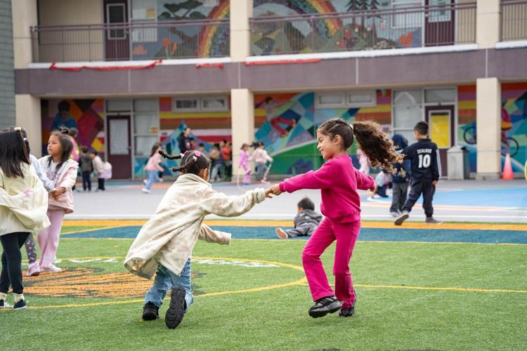 Students play on the new synthetic turf field at Monroe Elementary School in San Francisco, one of 14 school field projects supported through a partnership between Playing for Keeps Foundation and America SCORES Bay Area.