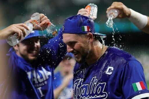 Italy captain Vinnie Pasquantino is showered with water after his team's defeat of Mexico