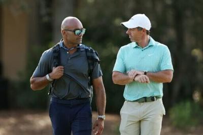 Second-ranked Rory McIlroy, right, of Northern Ireland speaks to performance coach Rohin Sharma at the Players Championship