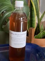 Farmers market vendor sells worm tea and candies