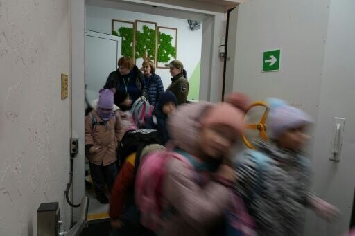 Children leave an underground school in Kharkiv
