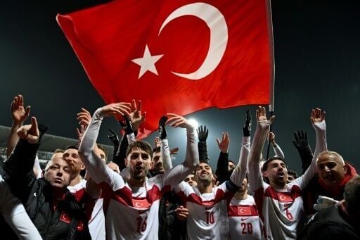Turkey players celebrate after beating Kosovo in Pristina to qualify for the World Cup