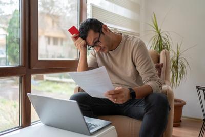 Stressed Desperate Man Looking Frustrated To Unpaid Bills