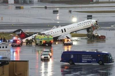 An Air Canada Express CRJ-900 sits on the runway after colliding with a Port Authority fire truck at LaGuardia Airport in New York,