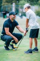 Personal Golf Lesson for Children. Instructor Teaching Young Boy How to Play Golf.